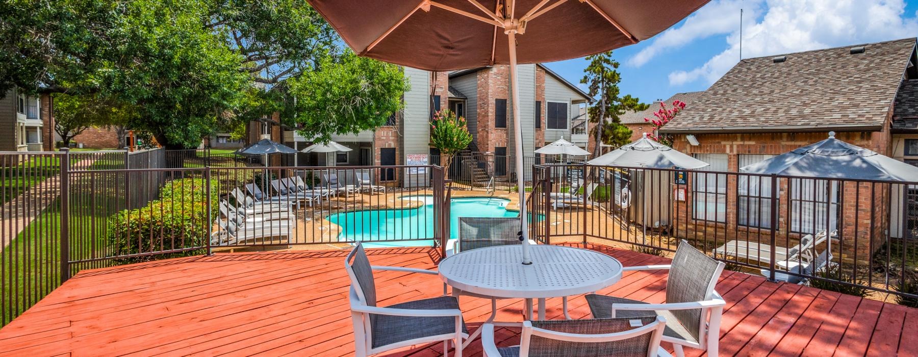 a patio with tables and chairs